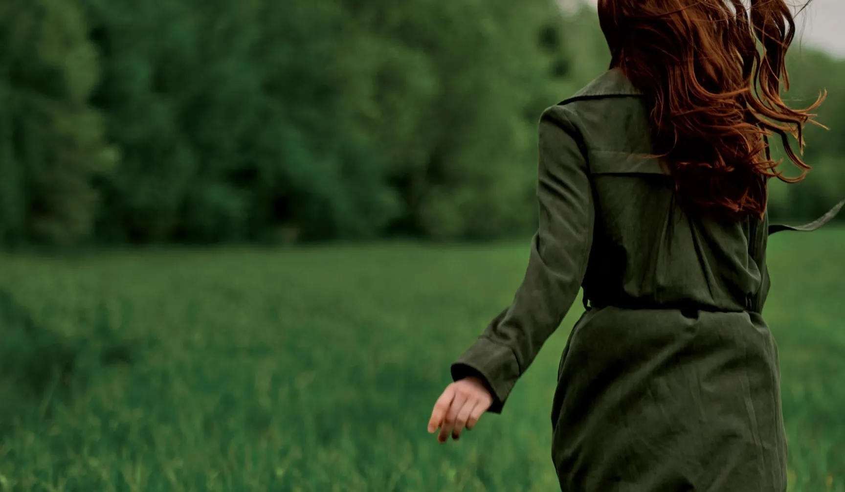 Woman enetring beautiful green woods