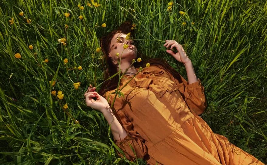 Woman sitting in tall grass