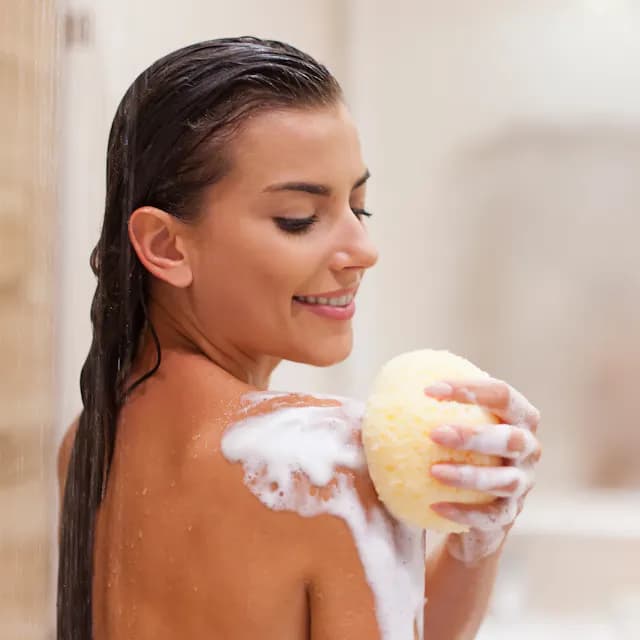 Young woman taking a shower